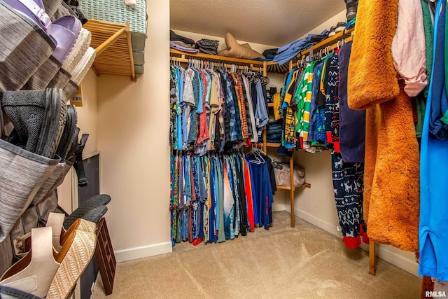 walk in closet with carpet