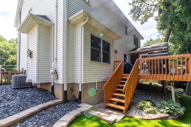 rear view of property featuring central air condition unit and a deck