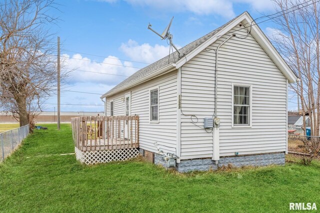 view of home's exterior with a wooden deck and a yard