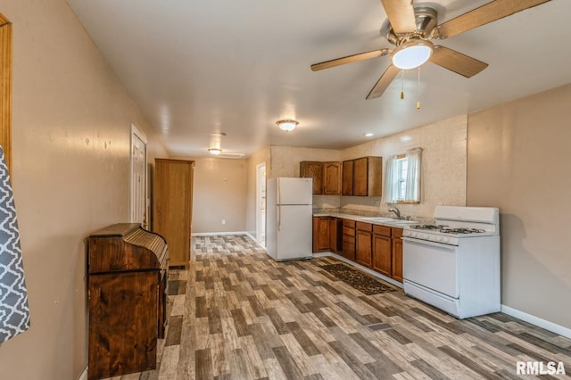 kitchen featuring ceiling fan, sink, wood-type flooring, and white appliances