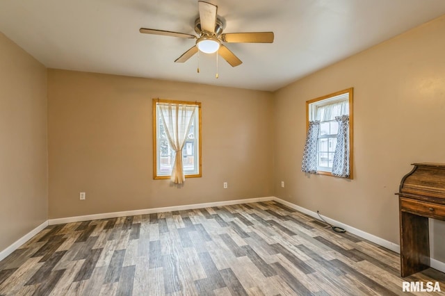 spare room with ceiling fan and hardwood / wood-style flooring