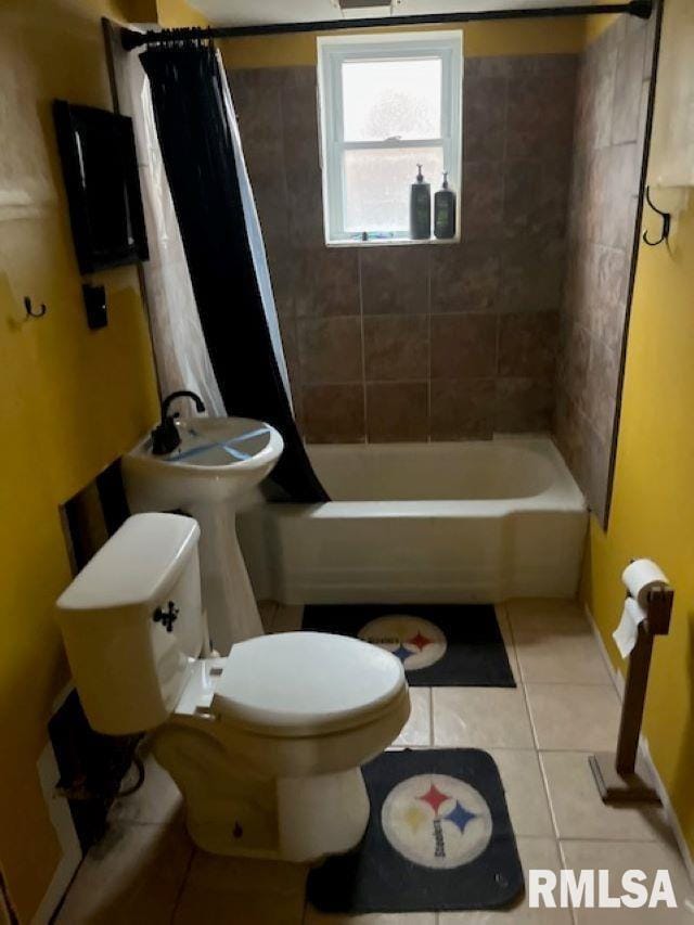 bathroom with toilet, tile patterned floors, and shower / bath combo with shower curtain