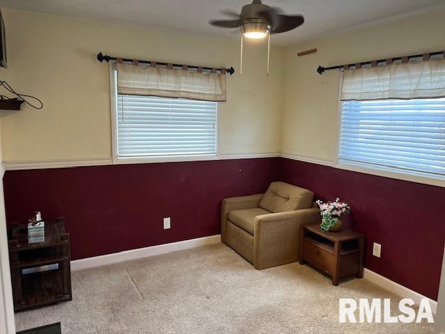 sitting room featuring light carpet and ceiling fan