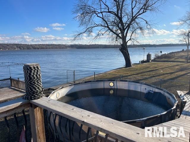 dock area with a water view and a hot tub