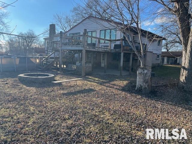 rear view of house with a deck with water view