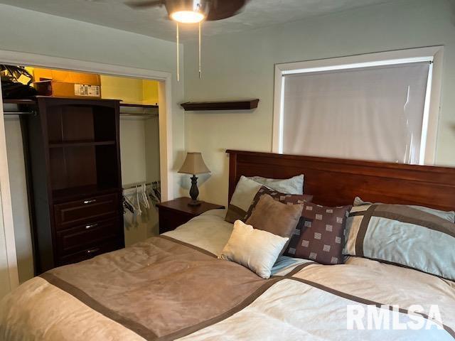 bedroom featuring ceiling fan and a closet