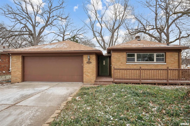 view of front of property with a wooden deck, a garage, brick siding, and concrete driveway