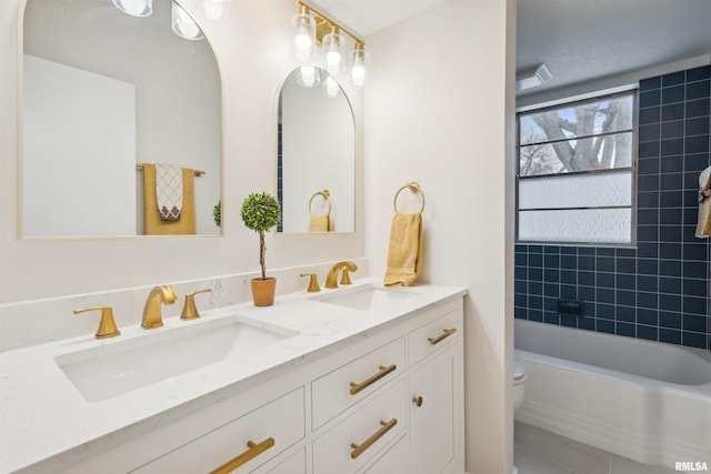 full bathroom featuring vanity, toilet, and tiled shower / bath combo