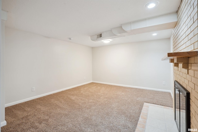 interior space with light colored carpet and a brick fireplace