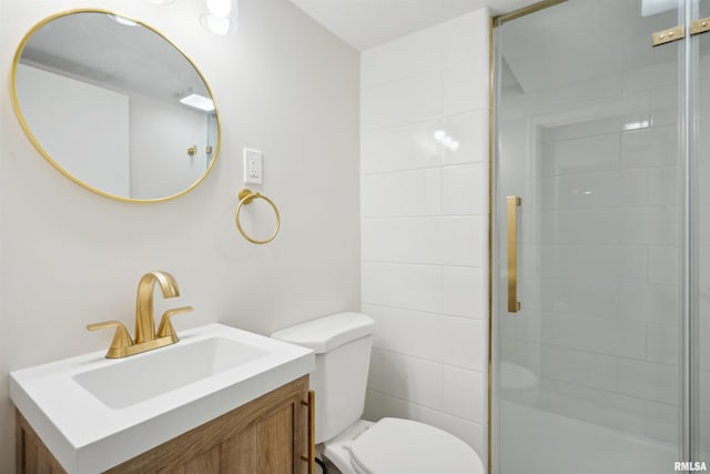 bathroom with a shower with door, toilet, and vanity