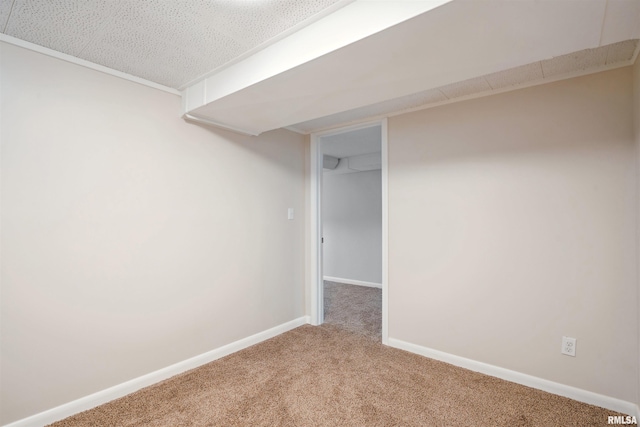 basement featuring a textured ceiling and carpet flooring