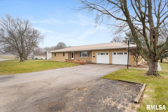 ranch-style home with a front yard and a garage