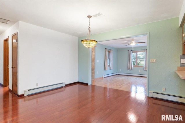 interior space with baseboard heating, hardwood / wood-style floors, and ceiling fan with notable chandelier