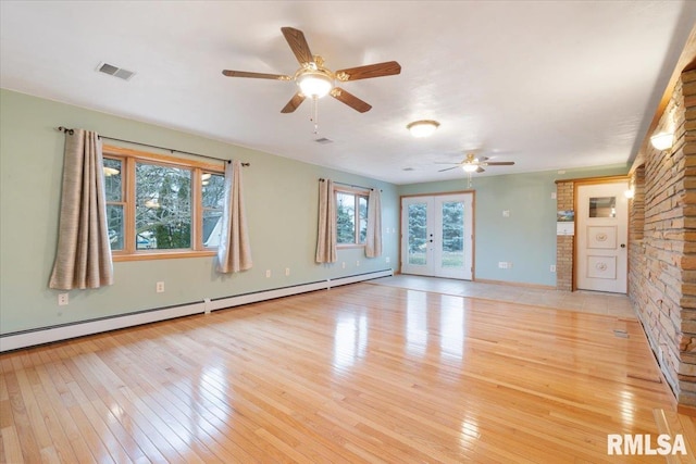 unfurnished room with baseboard heating, ceiling fan, french doors, and light hardwood / wood-style floors