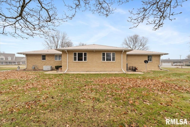 rear view of property featuring a yard