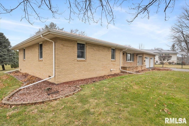 view of side of property with a yard and a garage