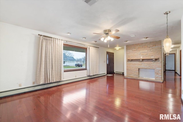 unfurnished living room featuring a fireplace, wood-type flooring, and baseboard heating