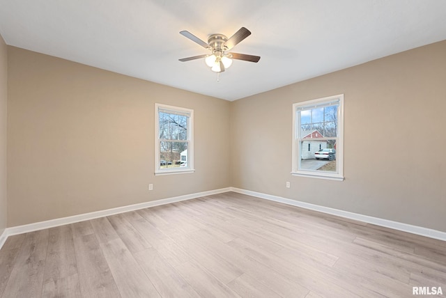 unfurnished room featuring ceiling fan, light wood-type flooring, and a wealth of natural light