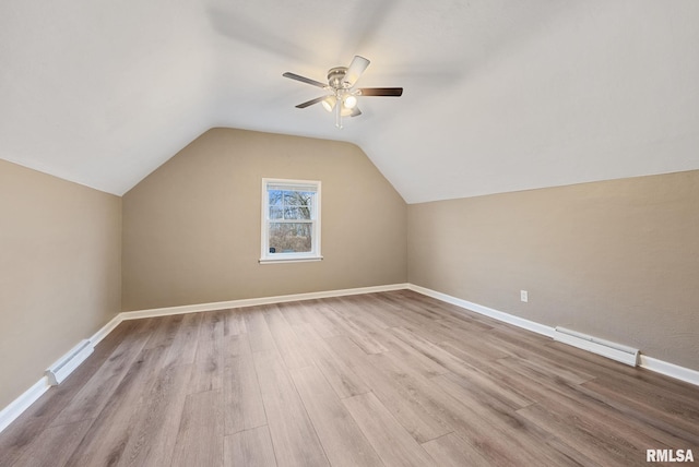 bonus room with lofted ceiling, ceiling fan, light wood-type flooring, and a baseboard heating unit