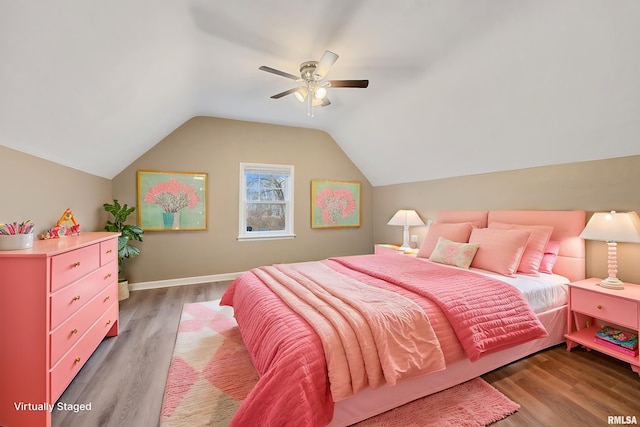 bedroom with vaulted ceiling, ceiling fan, and dark wood-type flooring