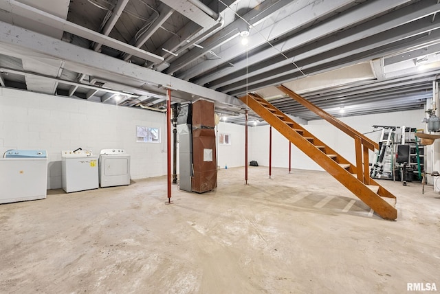 basement featuring heating unit and washer and dryer