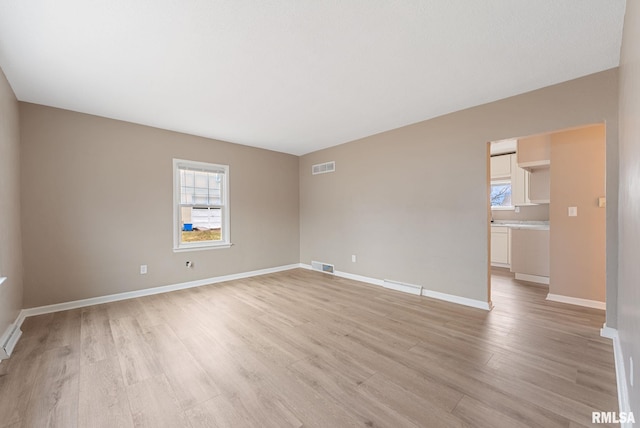 empty room with light hardwood / wood-style flooring