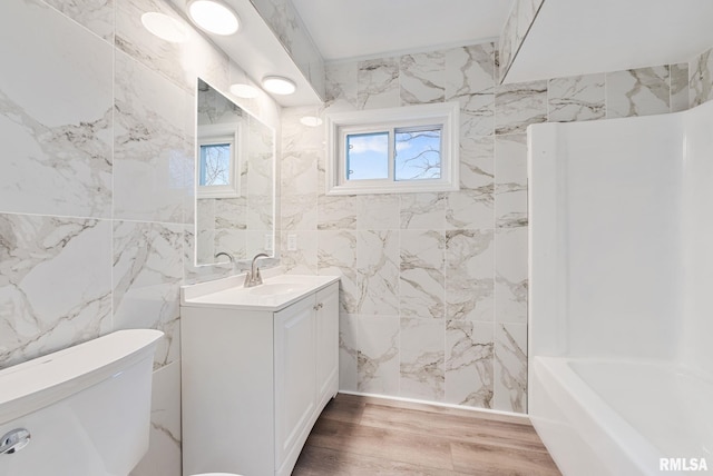 bathroom featuring hardwood / wood-style flooring, vanity, and toilet