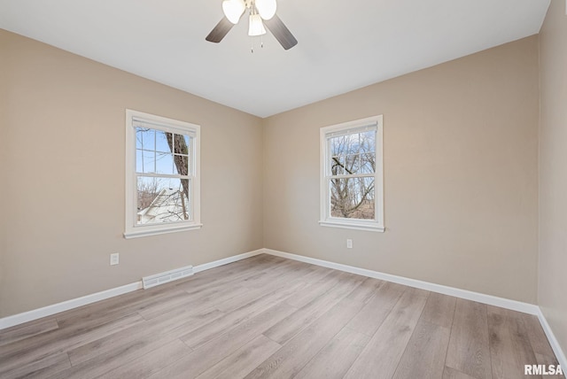 empty room featuring ceiling fan and light hardwood / wood-style flooring