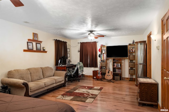 living room featuring a textured ceiling and light hardwood / wood-style floors