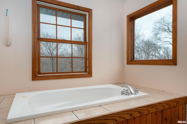 bathroom with plenty of natural light and a relaxing tiled tub