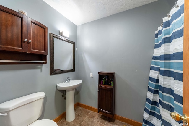 bathroom featuring tile patterned floors, walk in shower, a textured ceiling, and toilet