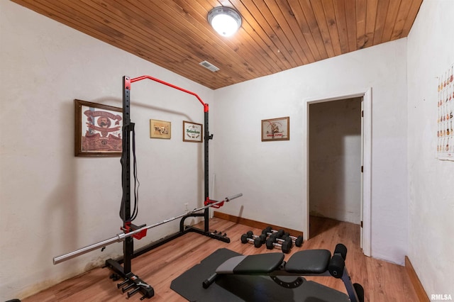 workout room with light wood-type flooring and wooden ceiling