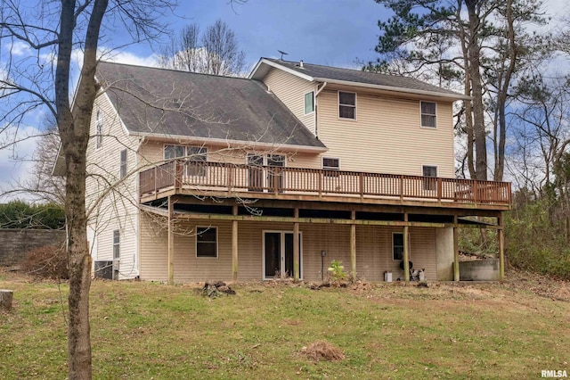 back of house featuring a wooden deck and a yard