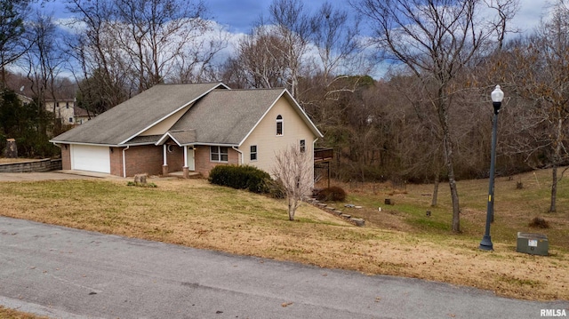 view of front of house with a garage and a front yard