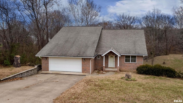 view of front of house featuring a garage and a front lawn