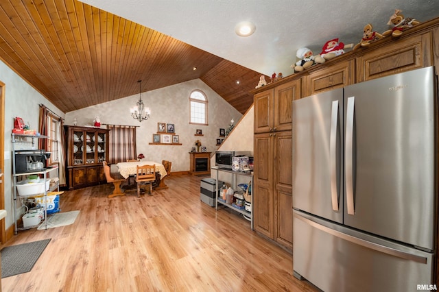 kitchen with stainless steel fridge, light wood-type flooring, high vaulted ceiling, wooden ceiling, and a notable chandelier