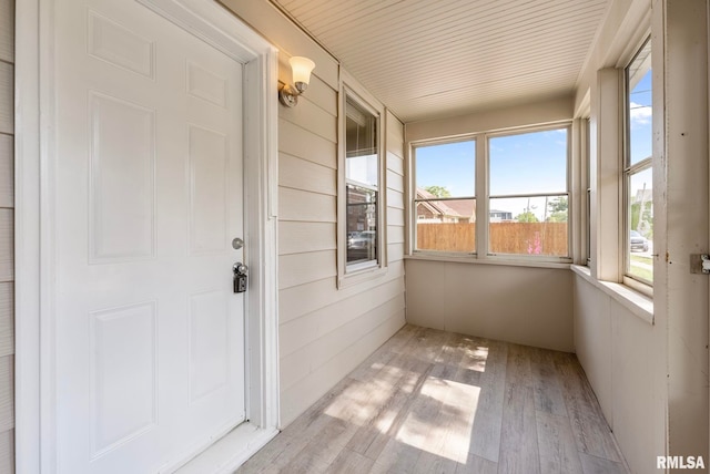 unfurnished sunroom with a wealth of natural light