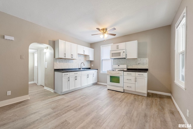 kitchen featuring white cabinetry and white appliances