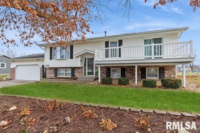 bi-level home with a garage and a front lawn