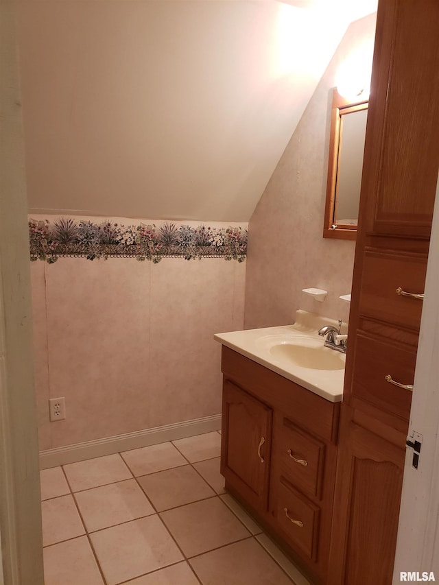 bathroom featuring vanity, lofted ceiling, and tile patterned floors