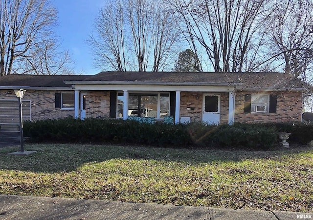 ranch-style home with cooling unit and a front yard