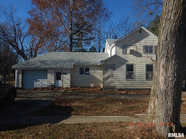 rear view of property with a garage