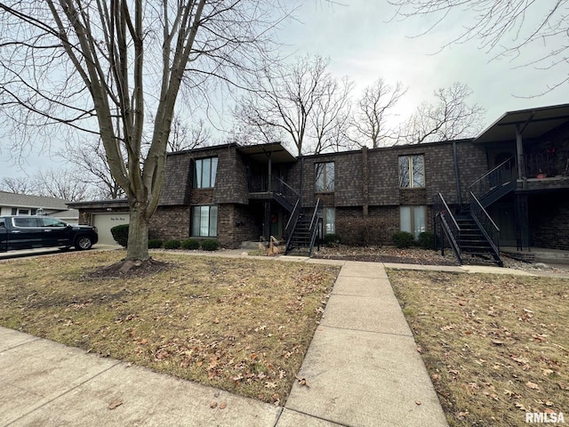 view of front of home featuring a garage and a front lawn