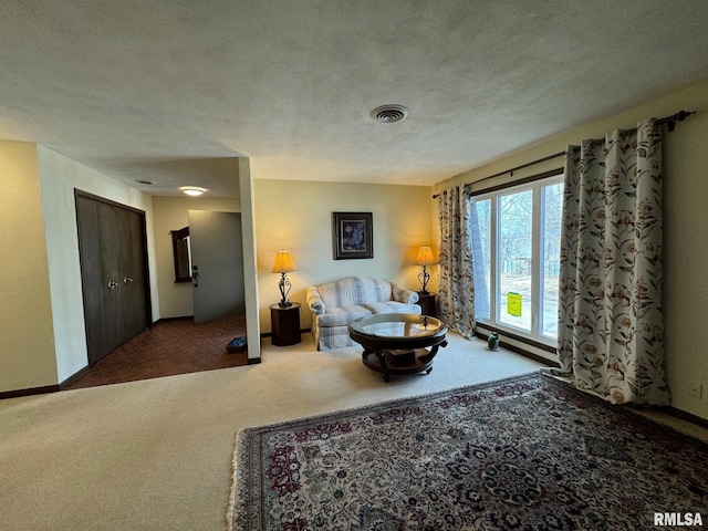 living area with dark carpet and a textured ceiling