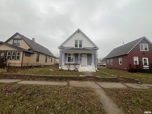 bungalow-style house with a front lawn and a porch