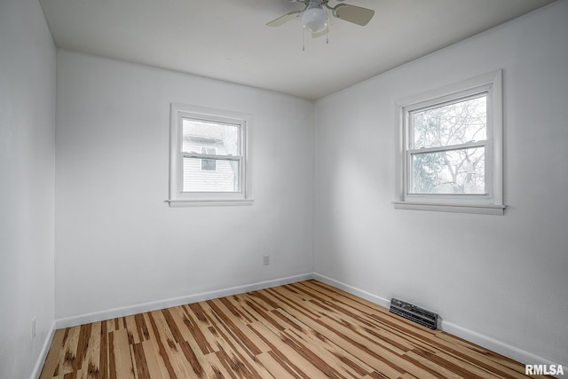 empty room featuring light wood-type flooring and ceiling fan