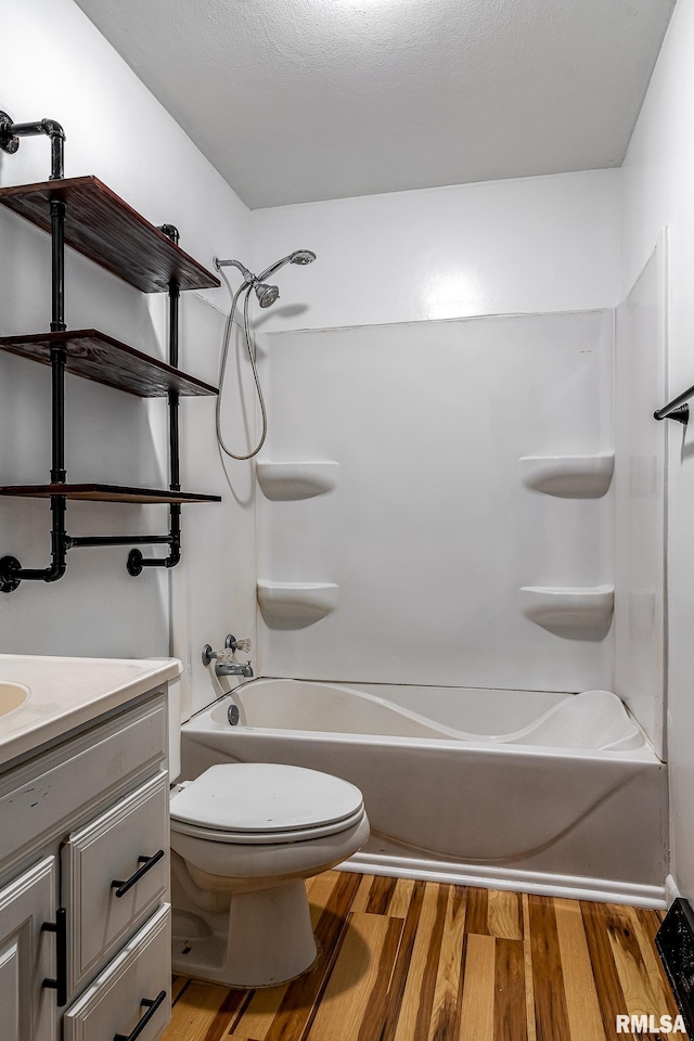 full bathroom with vanity,  shower combination, toilet, and wood-type flooring