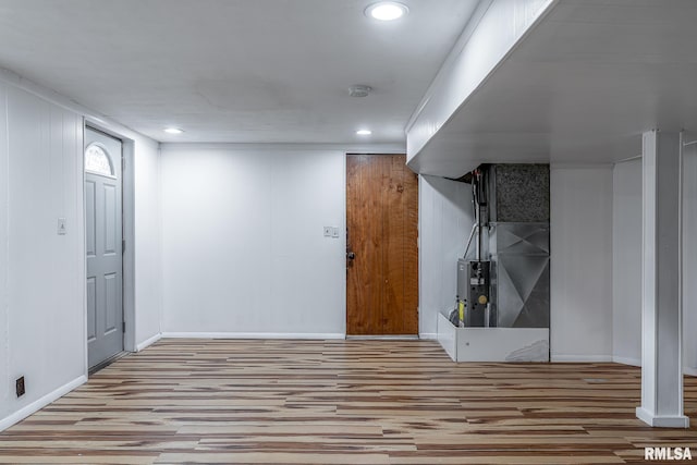 basement with light hardwood / wood-style floors