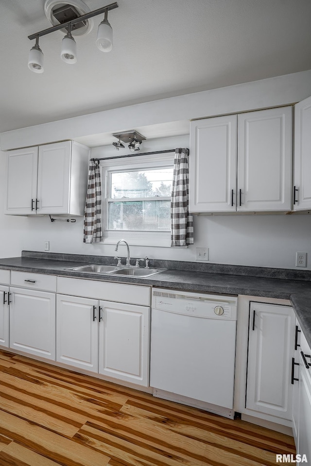 kitchen with dishwasher, track lighting, sink, light hardwood / wood-style floors, and white cabinetry