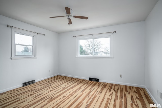 empty room featuring light hardwood / wood-style flooring and ceiling fan